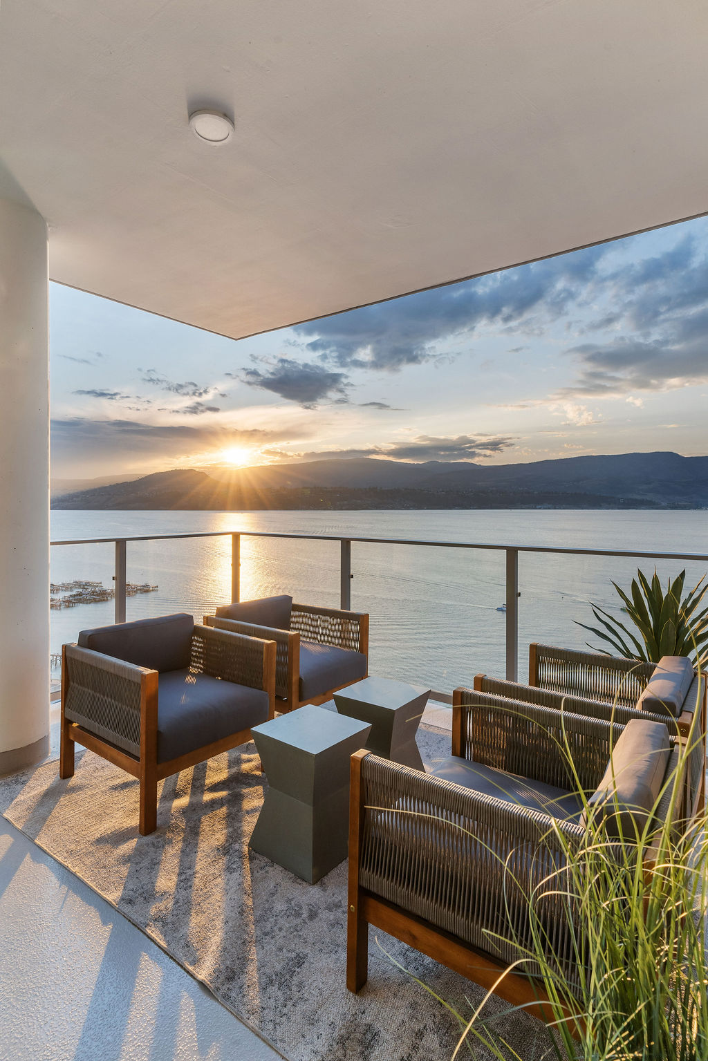 Furnished Aqua balcony overlooking Okanagan Lake and the mountains at sunset